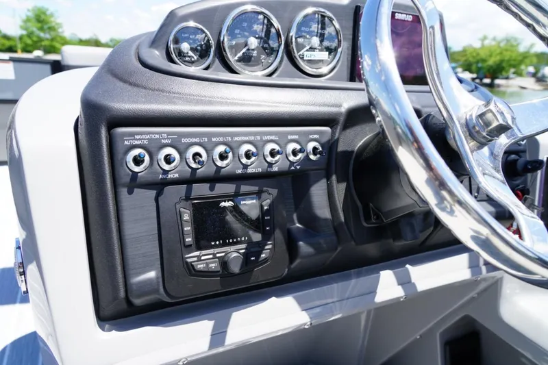 Slide: The Image of 2026 Berkshire 24 RFX CTS boat dashboard with controls and steering wheel. - 10