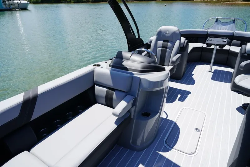 Slide: The Image of 2026 Berkshire 24 RFX CTS pontoon boat interior with luxurious seating on a serene lake. - 11