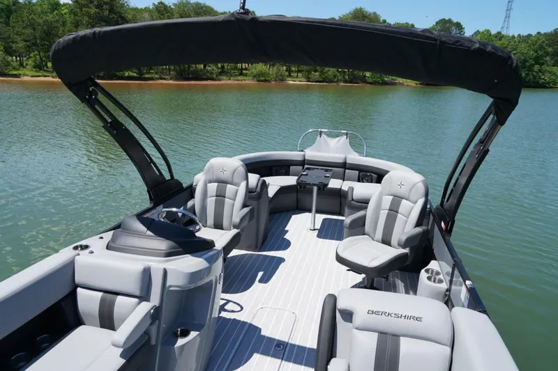 Slide: The Image of 2026 Berkshire 24 RFX CTS pontoon boat with luxurious seating on a serene lake. - 12