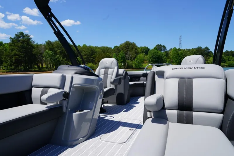 Slide: The Image of 2026 Berkshire 24 RFX CTS pontoon boat interior with luxurious seating and scenic lake view. - 13