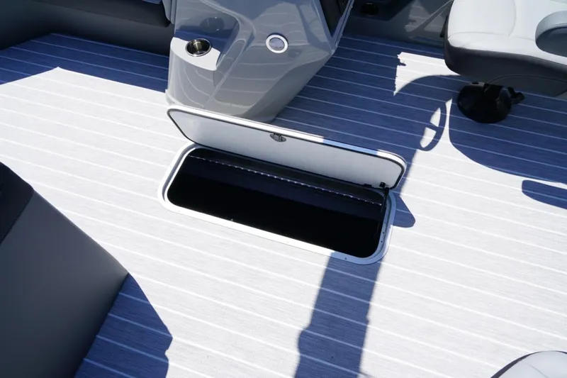 Slide: The Image of Open storage compartment on 2026 Berkshire 24 RFX CTS boat deck. - 15