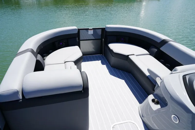 Slide: The Image of Luxurious seating on 2026 Berkshire 24 RFX CTS pontoon boat, overlooking serene water. - 16