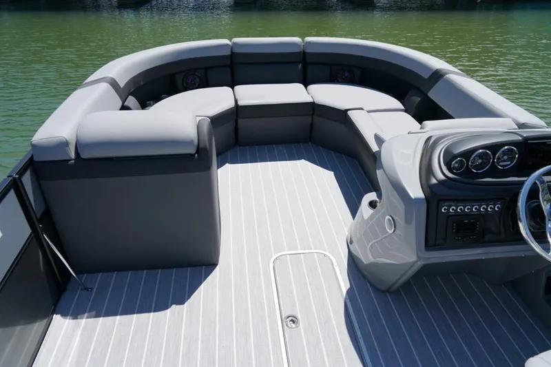 Slide: The Image of 2026 Berkshire 24 RFX CTS pontoon boat interior with plush seating and modern dashboard. - 17