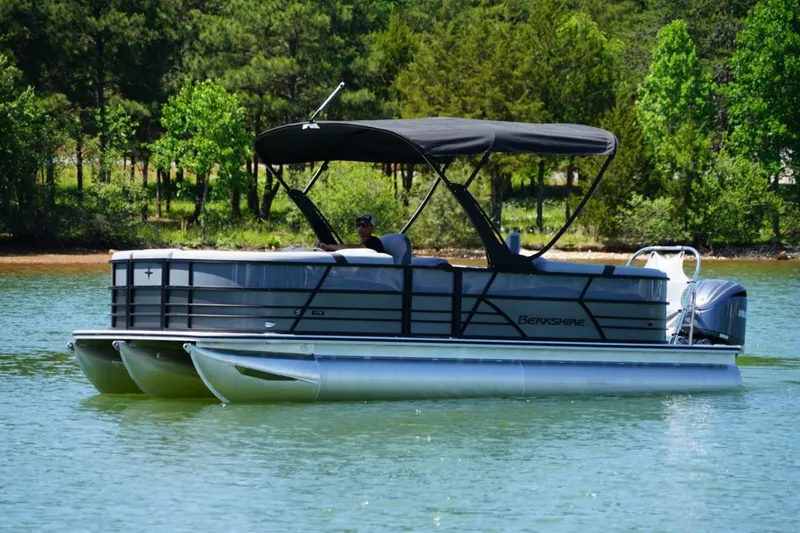 Slide: The Image of 2026 Berkshire 24 RFX CTS pontoon boat cruising on a serene lake. - 2