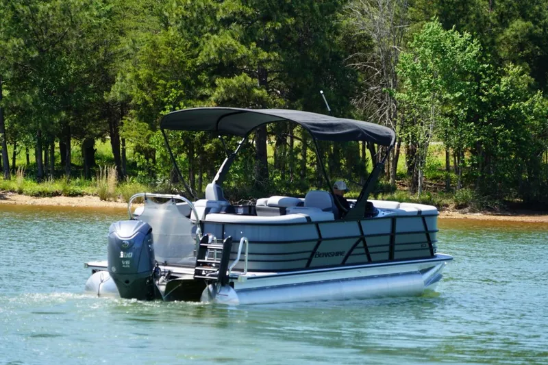 Slide: The Image of 2026 Berkshire 24 RFX CTS pontoon boat cruising on a scenic lake. - 3