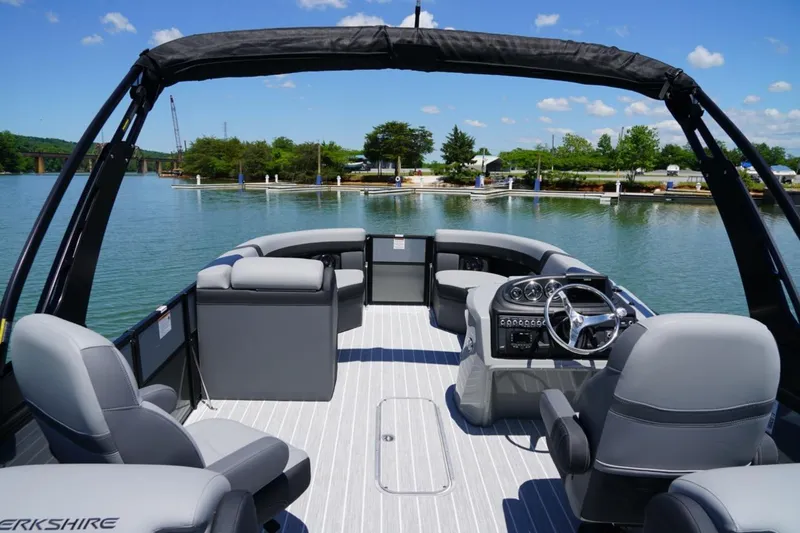 Slide: The Image of 2026 Berkshire 24 RFX CTS pontoon boat on a serene lake with clear skies. - 6