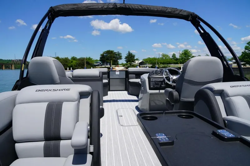 Slide: The Image of 2026 Berkshire 24 RFX CTS pontoon boat interior with plush seating and modern dashboard. - 7