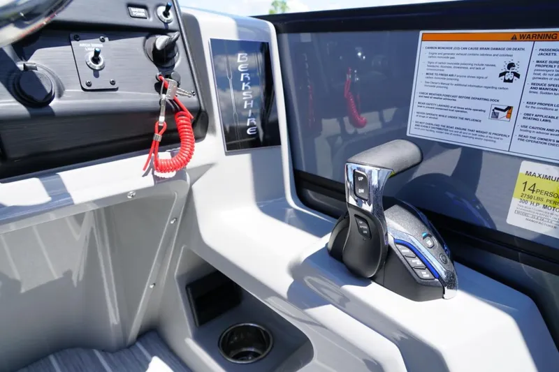 Slide: The Image of Control panel of a 2026 Berkshire 24 RFX CTS boat with throttle and safety features. - 8