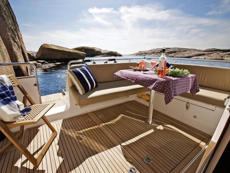 Slide: The Image of Luxurious Nimbus 365 Coupe yacht with elegant outdoor dining setup. - 2