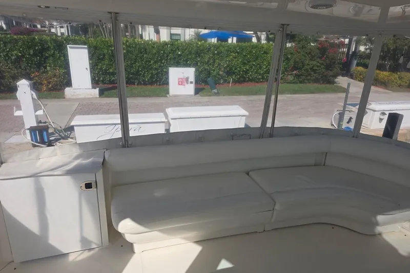 Slide: The Image of 2003 Sea Ray 390 Motor Yacht interior with white seating and marina view. - 19