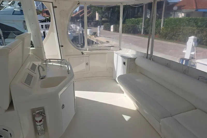 Slide: The Image of 2003 Sea Ray 390 Motor Yacht interior with seating, sink, and windows. - 20