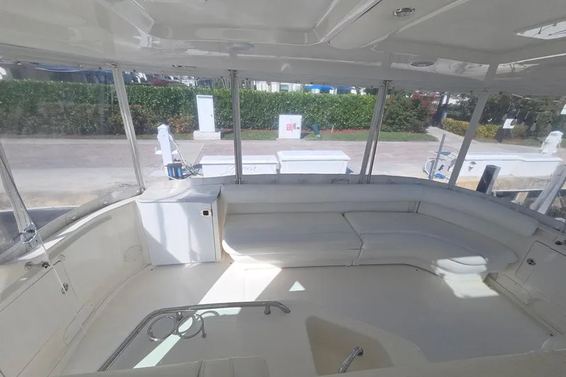 Slide: The Image of Spacious interior of 2003 Sea Ray 390 Motor Yacht with white seating and large windows. - 22