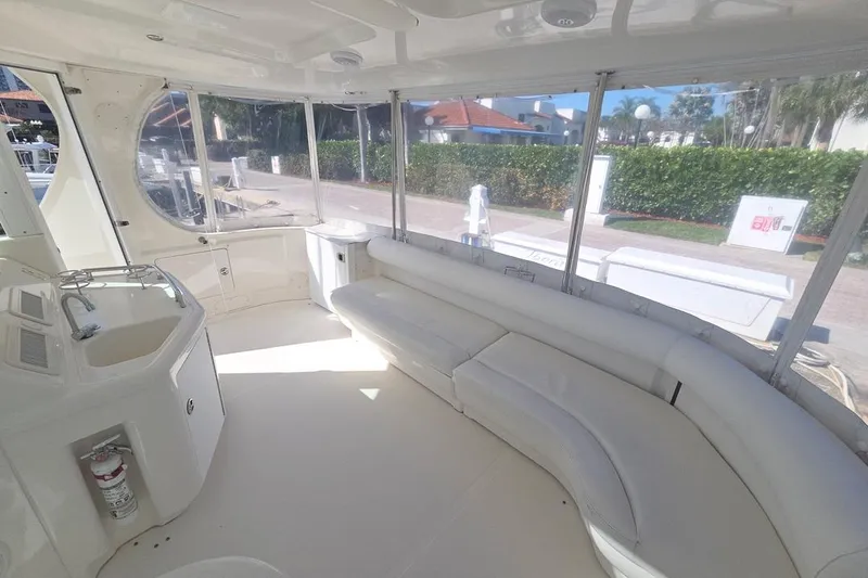 Slide: The Image of Spacious interior of 2003 Sea Ray 390 Motor Yacht with white seating and panoramic windows. - 23