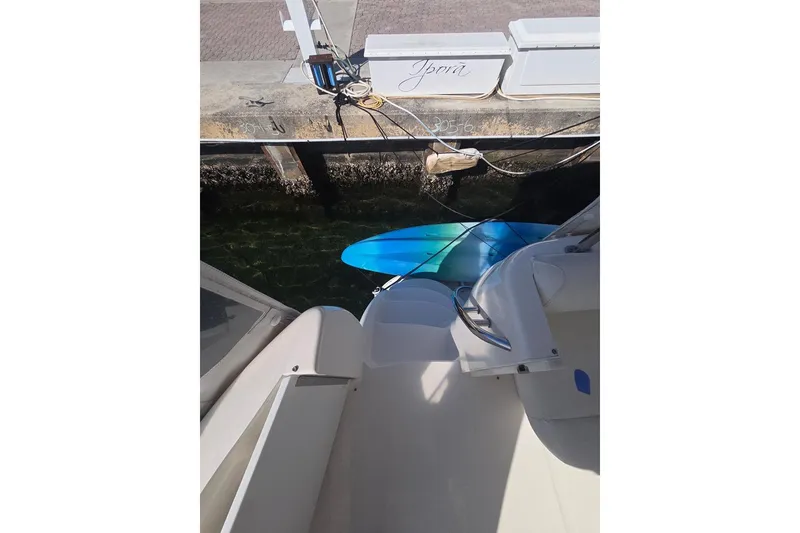 Slide: The Image of 2003 Sea Ray 390 Motor Yacht docked, with a blue kayak alongside. - 24