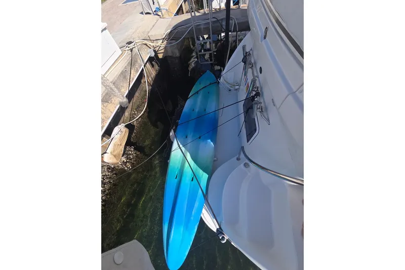Slide: The Image of 2003 Sea Ray 390 Motor Yacht docked with a blue kayak alongside. - 25