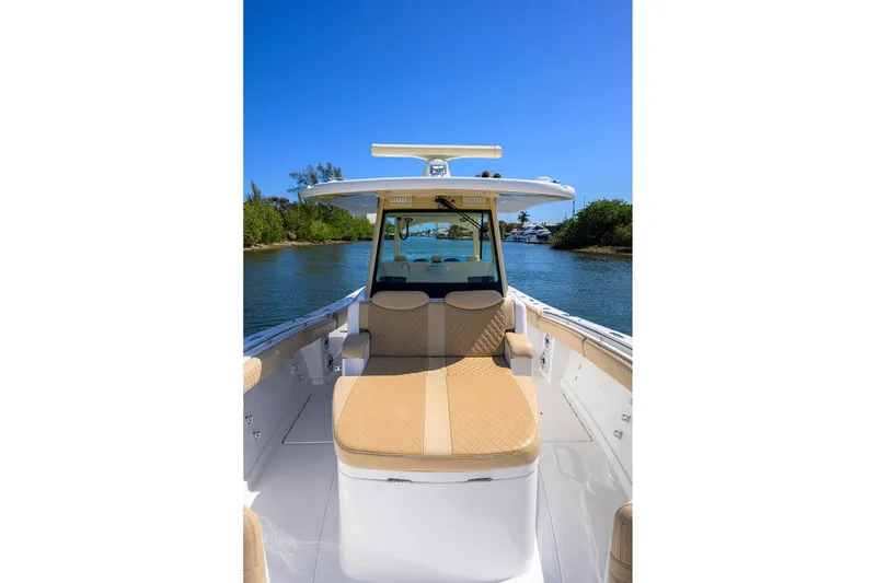 Slide: The Image of 2024 HCB 39 Speciale boat on water, featuring luxurious seating and sleek design. - 11