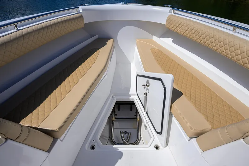 Slide: The Image of 2024 HCB 39 Speciale boat interior with tan quilted seating and storage compartment. - 12