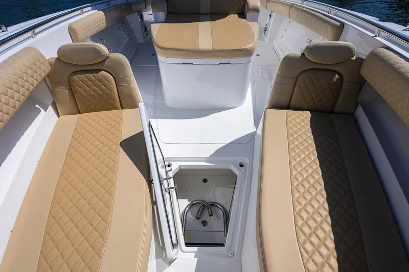 Slide: The Image of 2024 HCB 39 Speciale boat interior with tan quilted seating and storage compartment. - 13