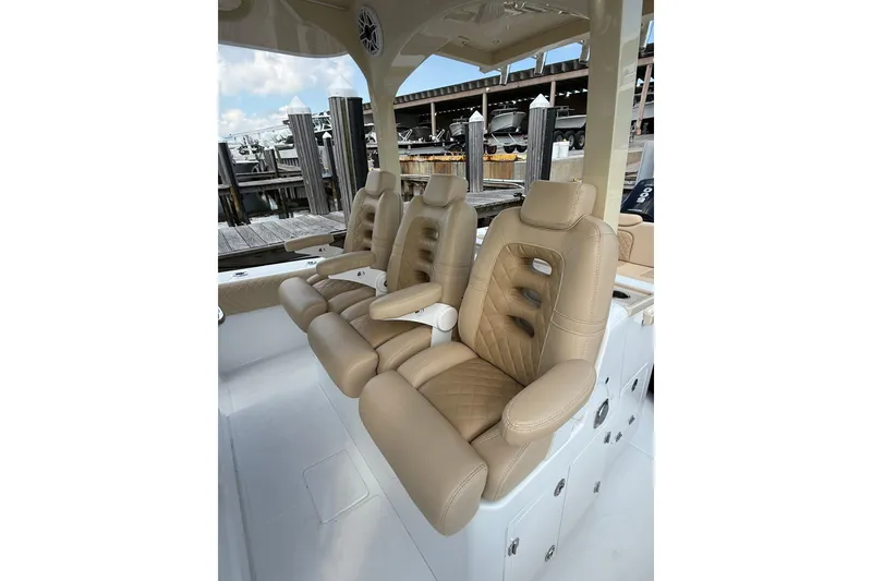 Slide: The Image of Luxurious seating on 2024 HCB 39 Speciale boat, featuring tan leather upholstery. - 2