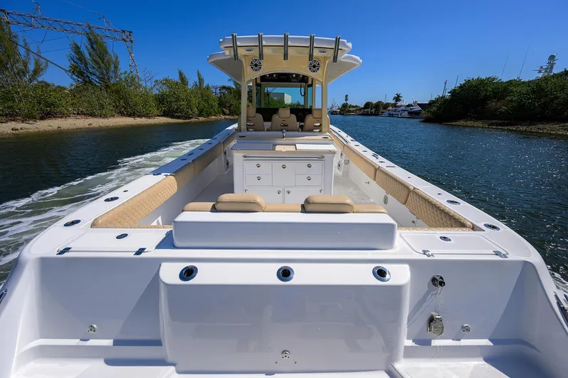 Slide: The Image of 2024 HCB 39 Speciale boat cruising on a sunny day, showcasing spacious deck and seating. - 20