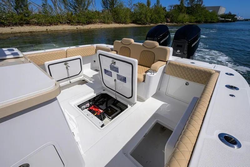 Slide: The Image of 2024 HCB 39 Speciale boat interior with open storage compartments and dual engines. - 26