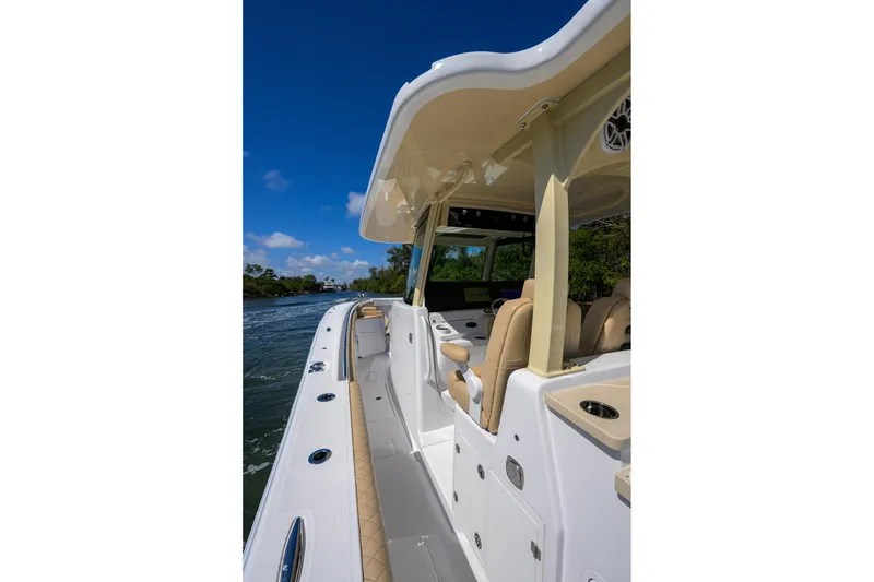 Slide: The Image of 2024 HCB 39 Speciale boat cruising on a sunny day, showcasing sleek design and luxury features. - 41