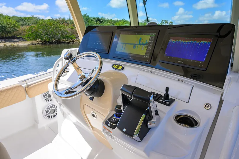 Slide: The Image of 2024 HCB 39 Speciale boat dashboard with advanced navigation screens and controls. - 45