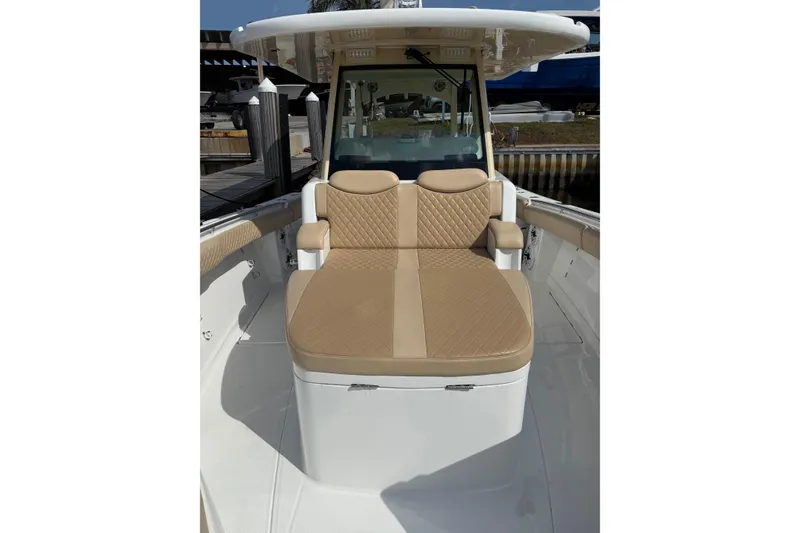 Slide: The Image of 2024 HCB 39 Speciale boat with tan cushioned seating and sleek design. - 5