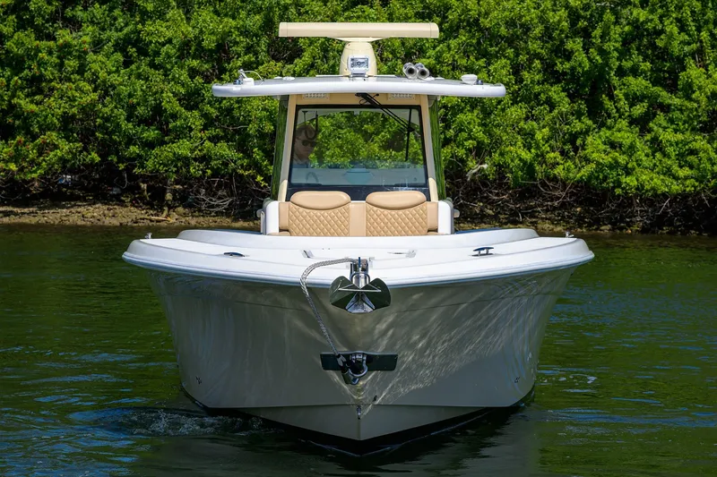 Slide: The Image of 2024 HCB 39 Speciale boat on water, lush greenery background. - 55