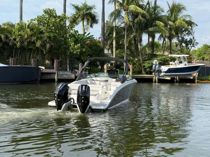 Slide: The Image of A 2026 Sea Ray SDX 290 Outboard navigates a calm waterway, surrounded by palm trees. - 11