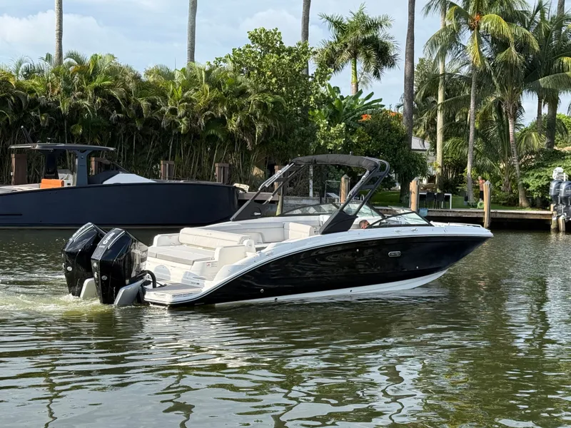 Slide: The Image of A sleek 2026 Sea Ray SDX 290 Outboard boat cruising on a calm waterway. - 8