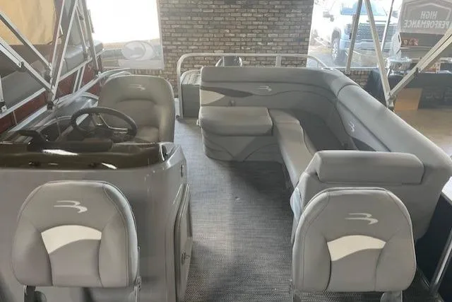 Slide: The Image of 2024 Bennington 18SFV Fishing Barge interior with gray seating and steering console. - 4