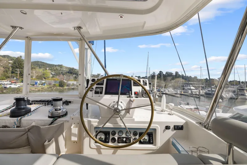 Slide: The Image of Helm of 2015 Leopard 58 yacht with steering wheel and navigation equipment, docked at marina. - 14
