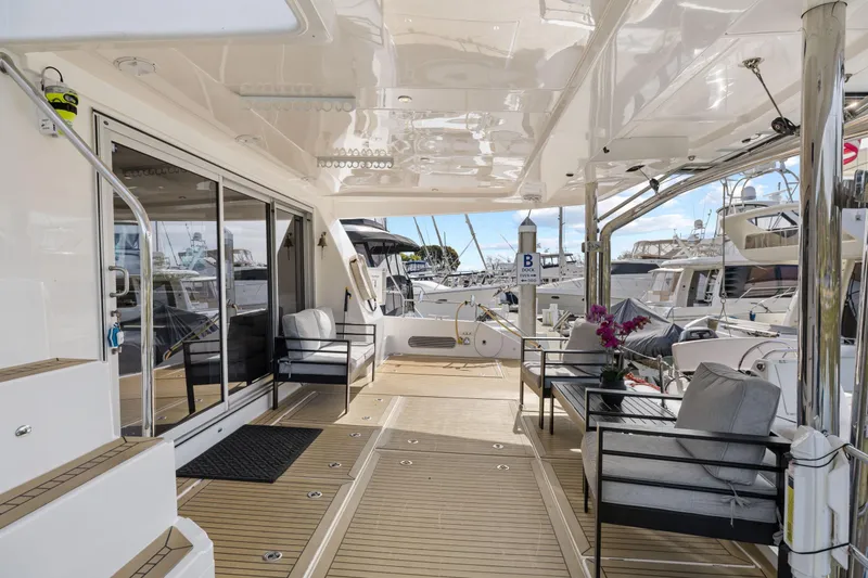 Slide: The Image of Luxurious 2015 Leopard 58 yacht deck with modern seating and marina view. - 15