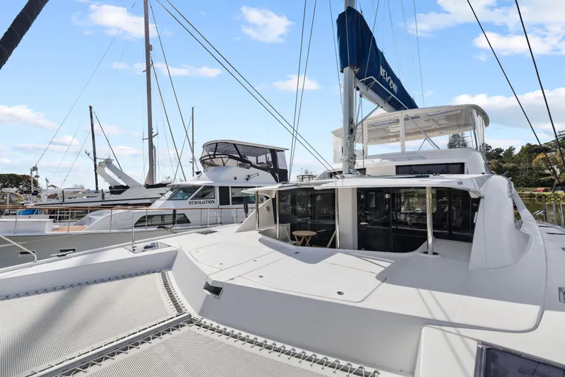 Slide: The Image of 2015 Leopard 58 catamaran docked at marina, featuring spacious deck and modern design. - 20