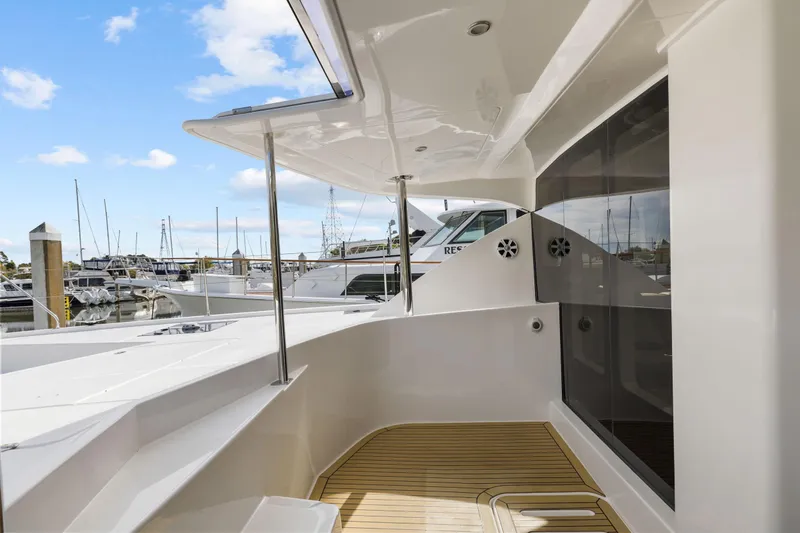 Slide: The Image of Luxury Leopard 58 yacht deck, 2015 model, docked at marina with clear blue sky. - 21