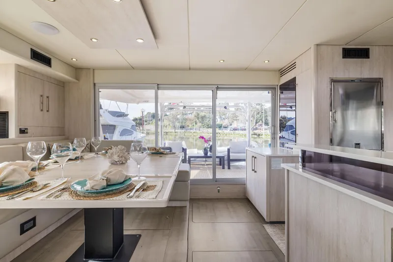 Slide: The Image of Luxurious dining area on 2015 Leopard 58 yacht with elegant table setting. - 25