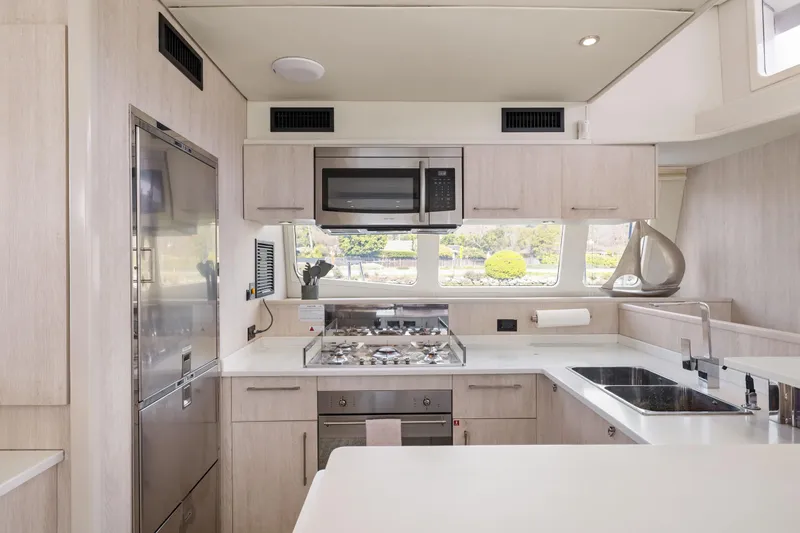 Slide: The Image of Modern kitchen interior on a 2015 Leopard 58 yacht, featuring sleek appliances and ample counter space. - 30