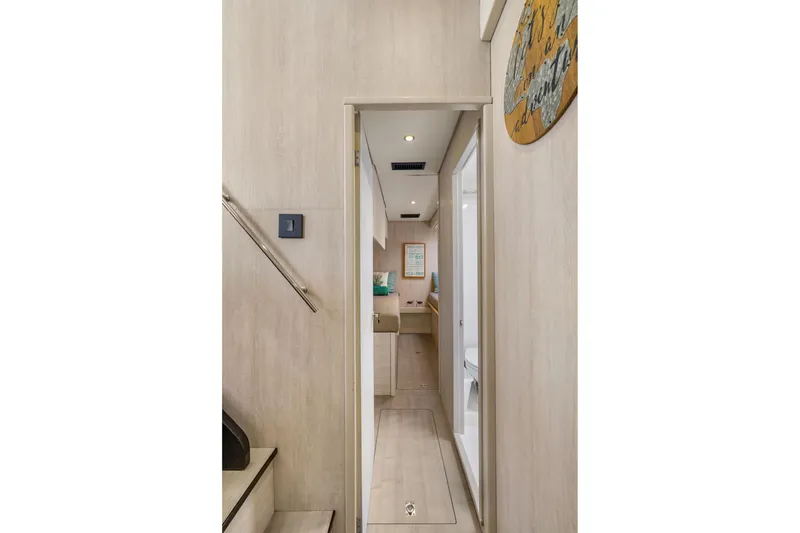Slide: The Image of Narrow hallway inside 2015 Leopard 58 yacht, featuring modern wooden interior and sleek design. - 57