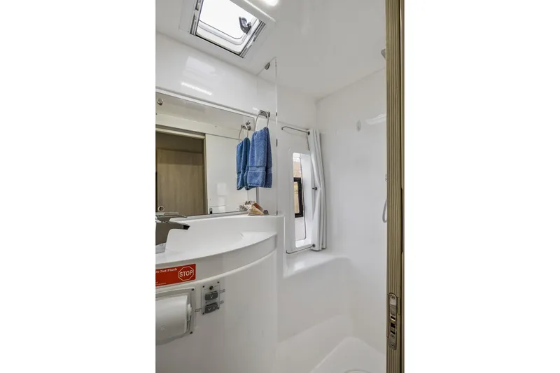 Slide: The Image of Compact bathroom in 2015 Leopard 58 yacht with skylight and blue towels. - 61