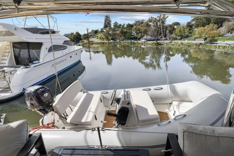 Slide: The Image of Luxury Leopard 58 yacht docked by serene waters, 2015 model, with inflatable boat. - 63