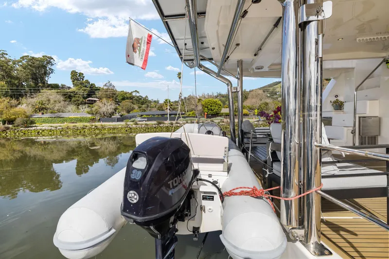 Slide: The Image of Luxury Leopard 58 yacht deck with inflatable boat and scenic waterfront view. - 64
