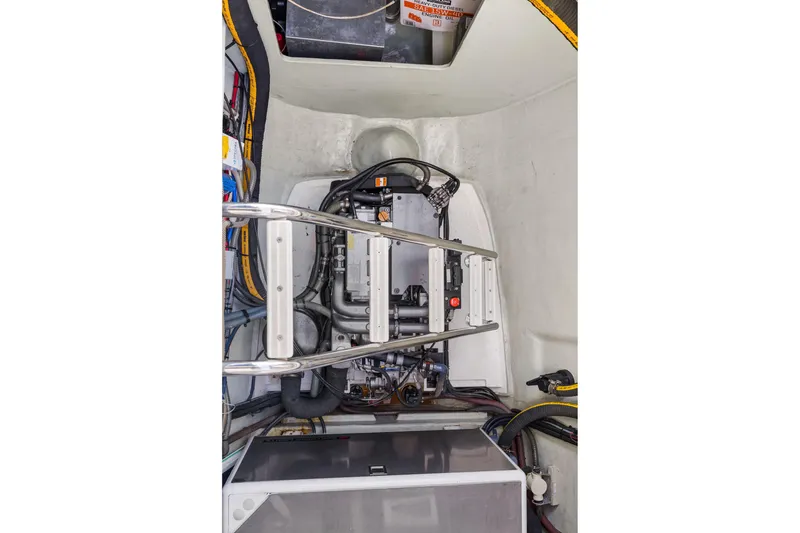 Slide: The Image of Engine room of a 2015 Leopard 58 yacht, showcasing mechanical components and wiring. - 65