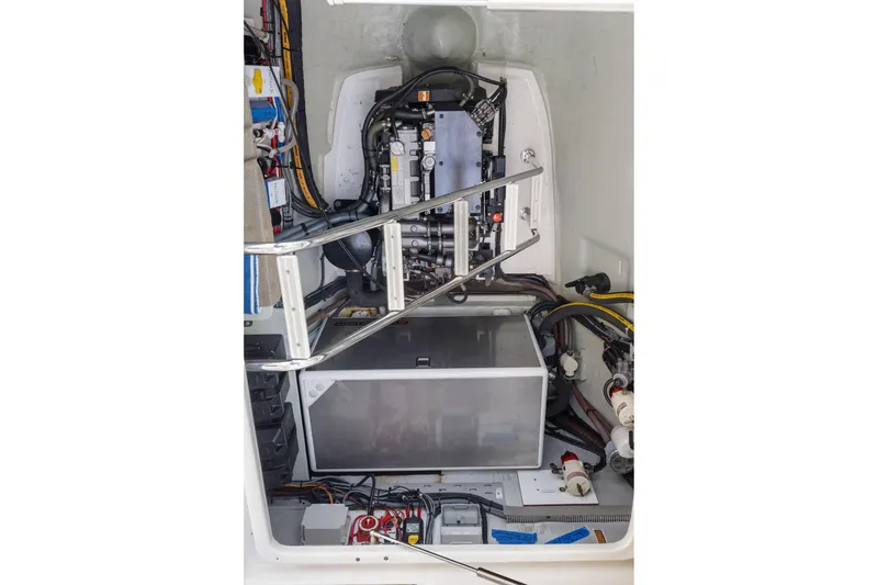 Slide: The Image of Engine compartment of a 2015 Leopard 58 yacht, showcasing mechanical components and wiring. - 66