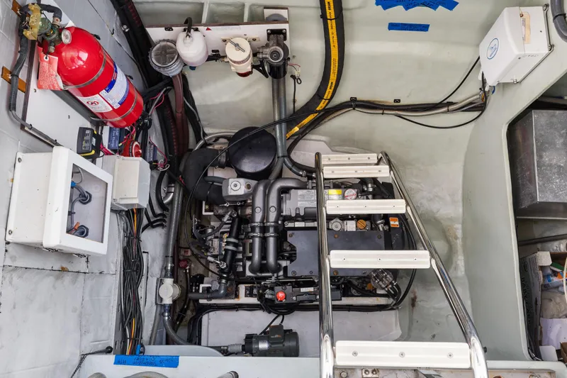 Slide: The Image of Engine room of a 2015 Leopard 58 yacht with visible machinery and fire extinguisher. - 67