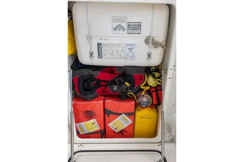Slide: The Image of Safety equipment storage on a 2015 Leopard 58 yacht, featuring life jackets and rescue gear. - 69