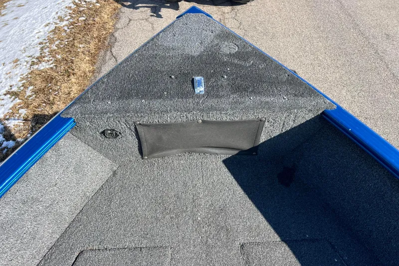 Slide: The Image of 2020 Lund 1675 Adventure Sport boat interior with gray carpet and blue trim. - 12