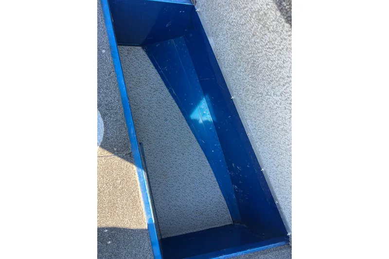 Slide: The Image of 2020 Lund 1675 Adventure Sport boat storage compartment, blue interior, textured surface. - 14