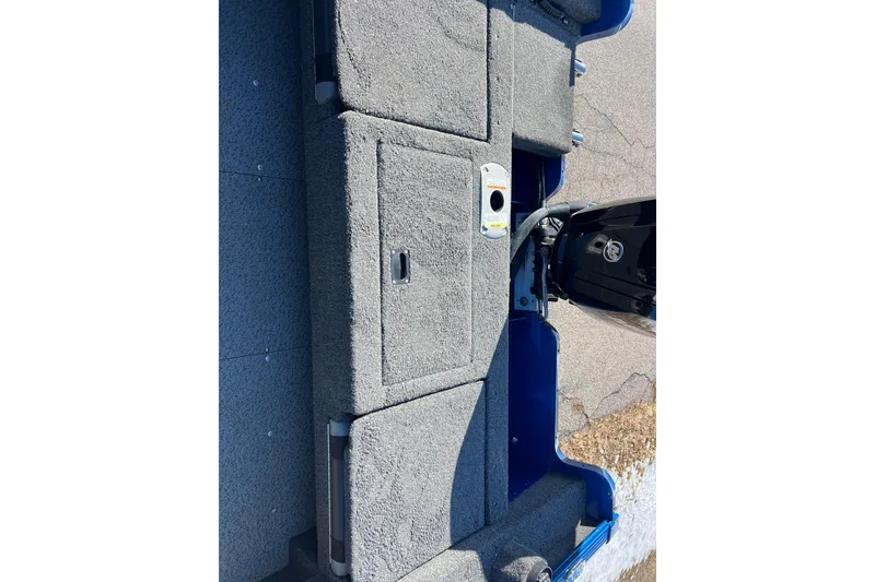 Slide: The Image of 2020 Lund 1675 Adventure Sport boat interior with carpeted deck and motor. - 17