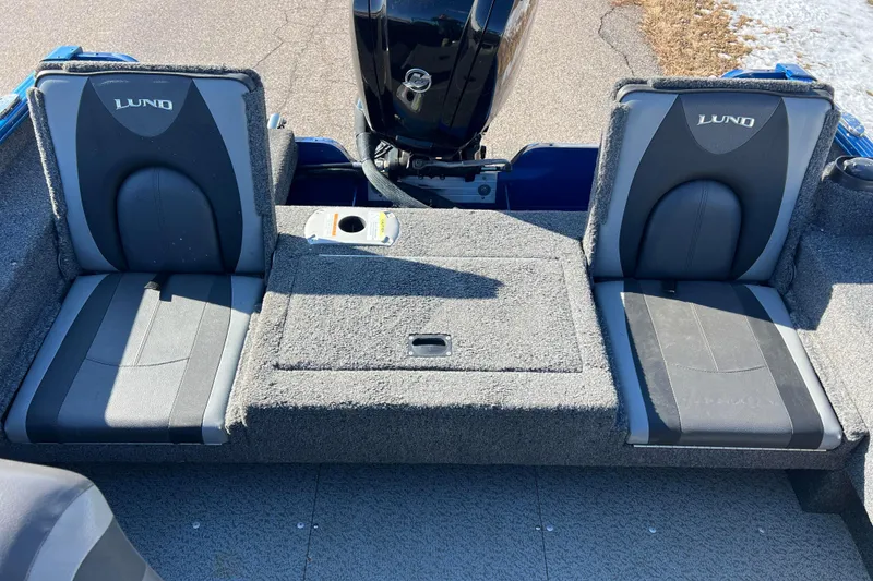 Slide: The Image of 2020 Lund 1675 Adventure Sport boat interior with two cushioned seats and motor. - 18